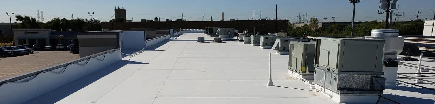 White TPO membrane commercial roof with rooftop HVAC units