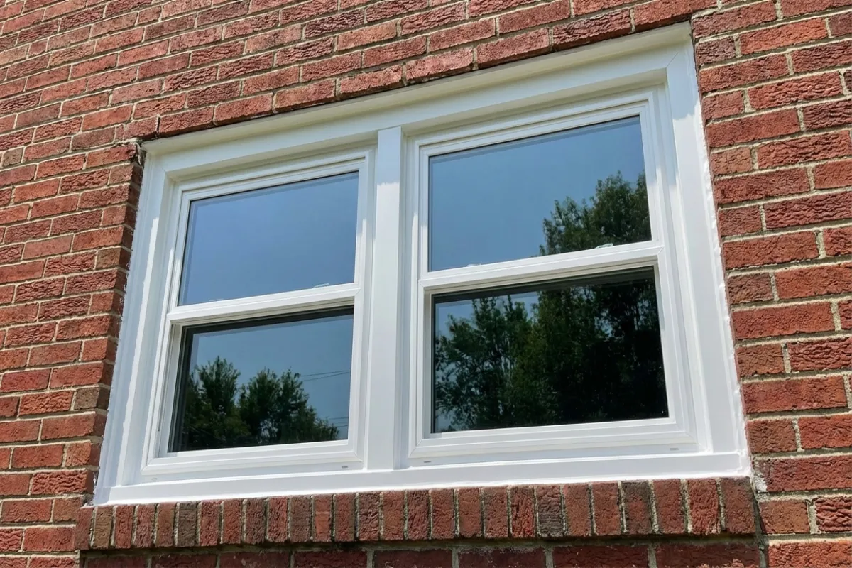 Double-hung vinyl window replacement on brick colonial home in Maryland