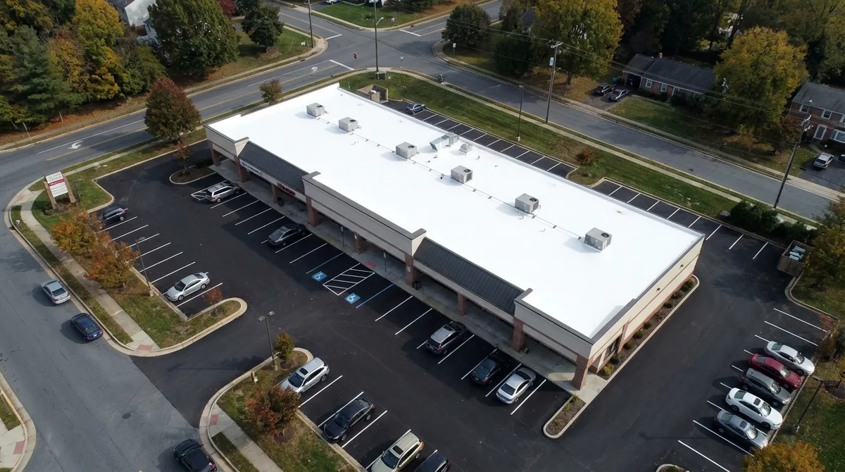 Aerial view of commercial building with new white TPO roof in Maryland
