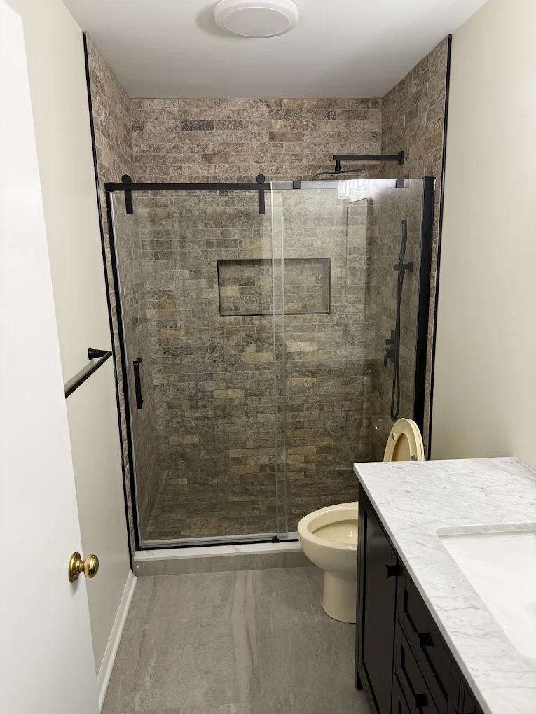 New roof on brick colonial home with Crown Remodeling yard sign