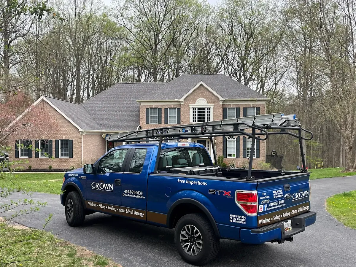 Crown Remodeling work truck at Maryland brick colonial home