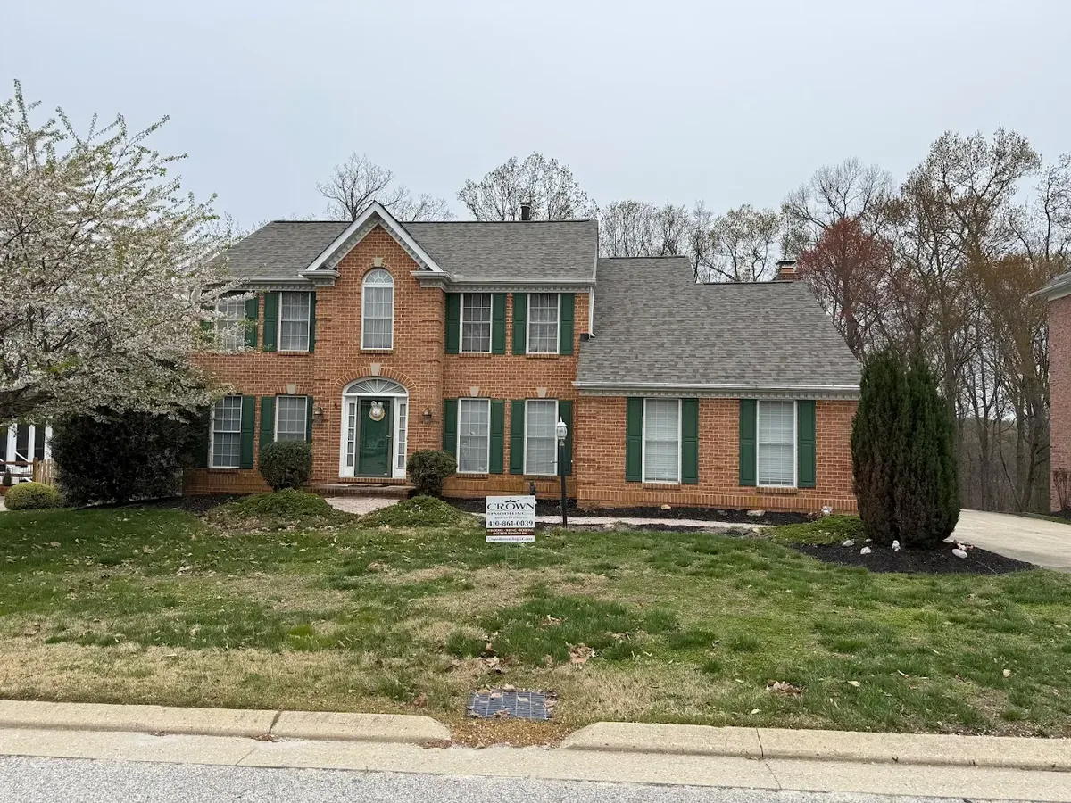 Drone view of completed roof replacement on luxury Maryland home with pool