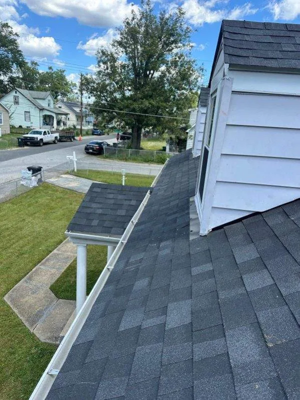 Charcoal shingle roof with new white gutters