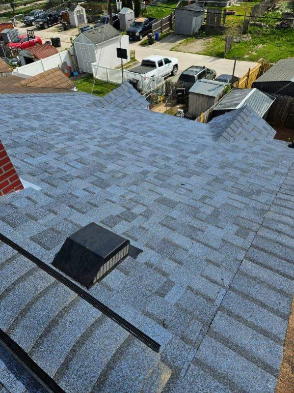 Gray shingle roof replacement with roof vent