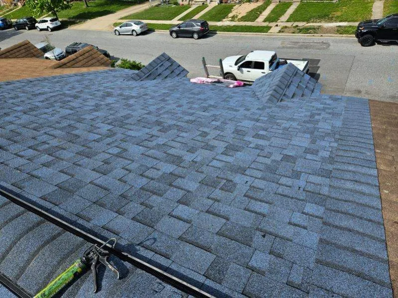 Crown Remodeling crew installing new roof on large brick home