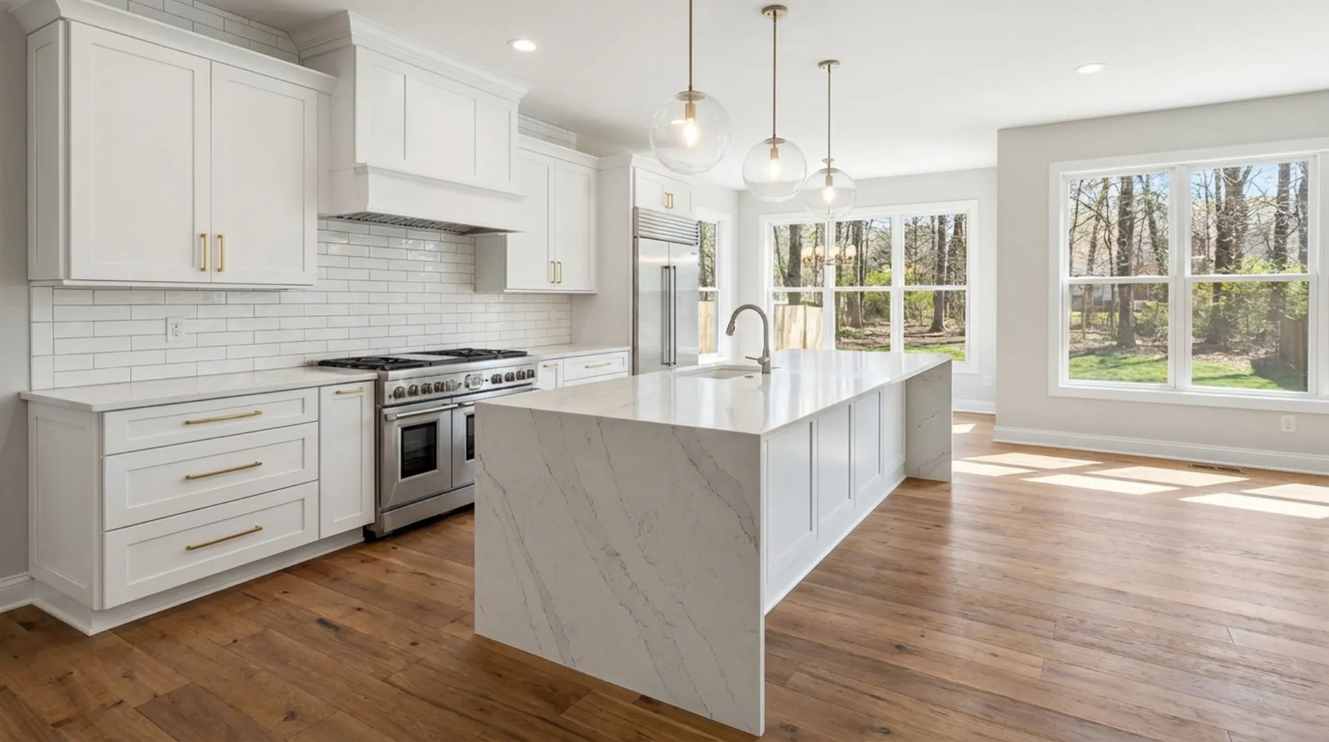 White shaker kitchen with quartz waterfall island in Maryland home